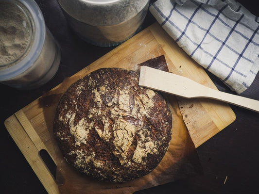 Crusty sourdough loaf on a wooden board